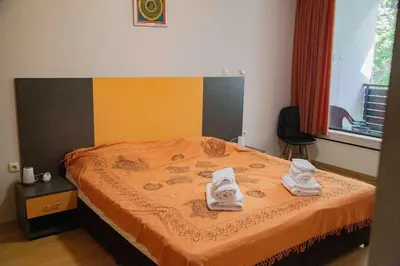 a bedroom with a bed with towels on it at Forest Dream Apartment - Elit Pamporovo in Pamporovo