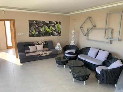 a living room with a couch and chairs and tables at Луксозна вила - Стрелча, джакузи с минерална вода in Strelcha