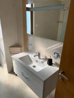 a bathroom with a white sink and a mirror at Луксозна вила - Стрелча, джакузи с минерална вода in Strelcha
