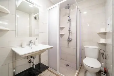a bathroom with a toilet and a sink and a shower at WOW studios for rent 2 bul Montevideo 25A - B in Sofia
