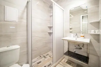 a bathroom with a shower and a toilet and a sink at WOW studios for rent 2 bul Montevideo 25A - B in Sofia