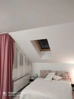 a bedroom with a white bed and a window at IGLIKA 2 SNOWY NIGHT V 31 in Borovets