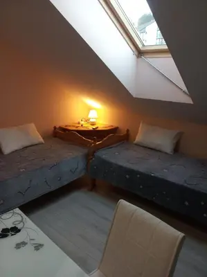 a room with two beds and a table and a window at IGLIKA 2 SNOWY NIGHT V 31 in Borovets