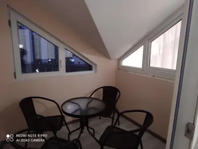 a room with chairs and a table and windows at IGLIKA 2 SNOWY NIGHT V 31 in Borovets