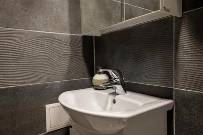 a bathroom with a sink and a mirror at Apartment City Home in Sofia