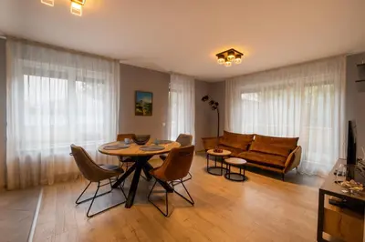 a living room with a table and a couch at Apartment City Home in Sofia