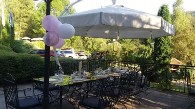 a table with balloons sitting under an umbrella at Hotel Perfect in Yamna