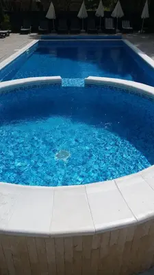 a large swimming pool with blue water at Hotel Perfect in Yamna