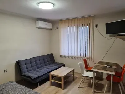 a living room with a couch and a table at Студиа Студенец in Smolyan