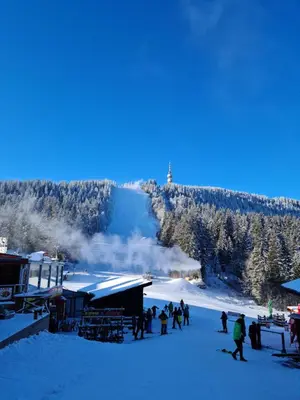 a group of people on a ski slope in the snow at Студиа Студенец in Smolyan