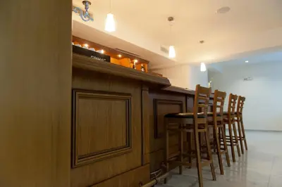 a bar with chairs and a table in a room at Hotel Astrea in Hisarya