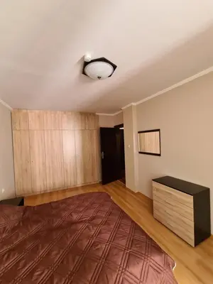 an empty room with a bed and a dresser at Родопски Рай in Pamporovo