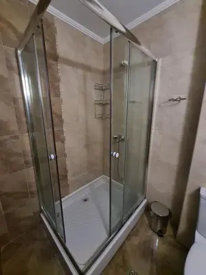 a shower with a glass door in a bathroom at Родопски Рай in Pamporovo