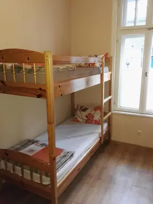 two bunk beds in a room with a window at Balkan Rooms & Studios in Downtown in Sofia