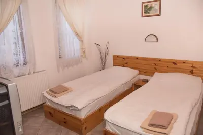 two twin beds in a small room with a tv at Villa Zaburdo in Zabŭrdo