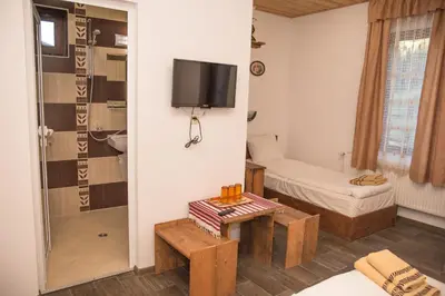 a room with a shower and a tv on a wall at Villa Zaburdo in Zabŭrdo