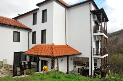 a white house with an orange roof at Family Hotel and Restaurant Plamena in Oreshak