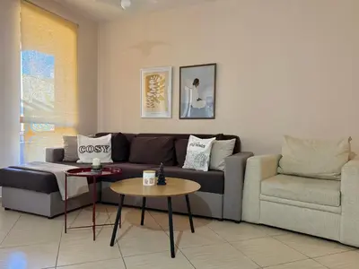 a living room with a couch and a table at Green life Bansko, 1 bedroom private apartment D4 in Bansko