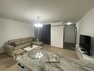 a living room with a couch and a television at Emily & Nasi in Plovdiv