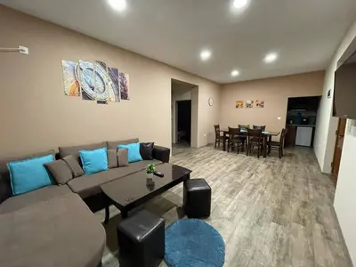 a living room with a couch and a table at Guest House Marchini in Sapareva Banya