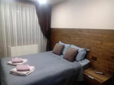a bedroom with a bed with two towels on it at КръчмЪ При Байката in Ribarica