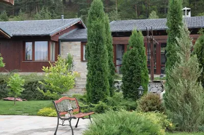 a bench in a garden in front of a house at Kameno in Banya