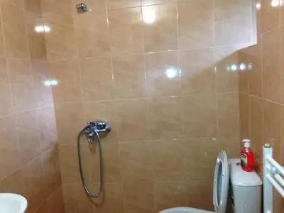 a shower stall in a bathroom with a toilet at Ristevata Guest House in Kovachevitsa