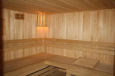 a wooden sauna with a wooden bench in it at Wood Apartment in Mountain View Complex in Bansko
