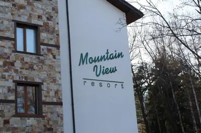 a sign for a mountain view resort on the side of a building at Wood Apartment in Mountain View Complex in Bansko