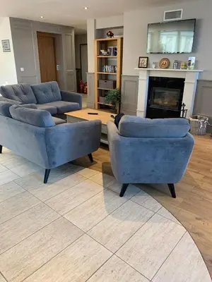 a living room with two blue couches and a fireplace at Wood Apartment in Mountain View Complex in Bansko