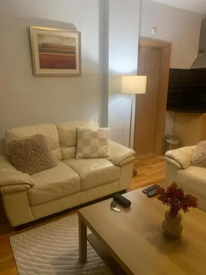 a living room with a couch and a coffee table at Wood Apartment in Mountain View Complex in Bansko