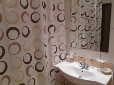 a bathroom with a sink and a mirror at Fortuna Complex Alexander Services Apartments in Bansko