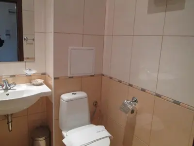 a bathroom with a toilet and a sink at Fortuna Complex Alexander Services Apartments in Bansko