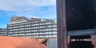 a large building with a sign on top of it at The Green King in Borovets