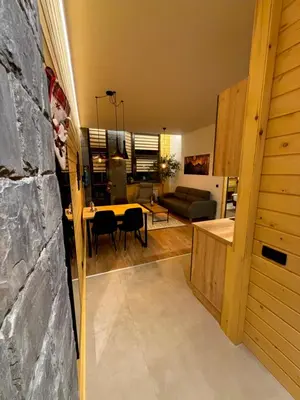 a living room and dining room with a table at Flora Hotel Apartment 103 in Borovets