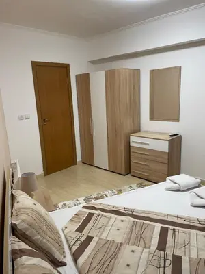 a bedroom with a bed and a dresser in it at Гранд Манастира , Пампорово in Pamporovo