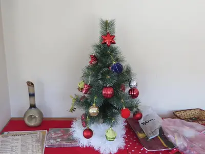 a christmas tree with ornaments on a table at Panoramic Apartment 301 in Eagle Rock Complex in Beli Iskar