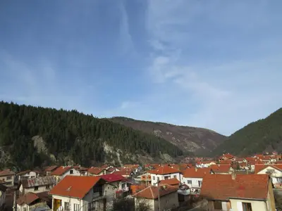 a group of houses in a town in the mountains at Panoramic Apartment 301 in Eagle Rock Complex in Beli Iskar