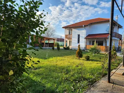 a house with a yard with green grass at Villa 