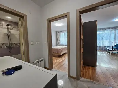 a room with a room with a bed and a mirror at Brand new apartment with free parking near city center in Sofia