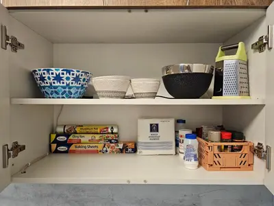 a pantry with bowls and other kitchen items on shelves at Brand new apartment with free parking near city center in Sofia