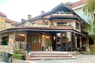 a restaurant with a sign on the front of a building at ,,Адела”-апартамент за гости in Velingrad