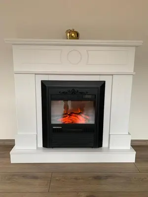 a fireplace with a fire inside of it at ,,Адела”-апартамент за гости in Velingrad