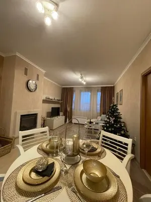 a living room with a table and a christmas tree at Grand Monastery Deluxe Pamporovo 5 B 3 in Pamporovo