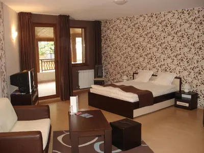 a bedroom with a bed and a living room at Стаи и апартаменти под наем in Borovets