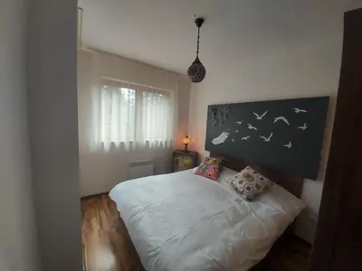 a bedroom with a white bed with two pillows at 1 Bedroom cozy flat in Pamporovo