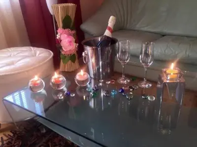 a glass coffee table with candles and wine glasses on it at Venis House in Plovdiv