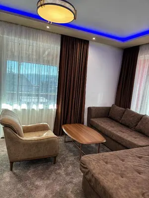 a living room with a couch and a table at Hotel Diamant in Dospat