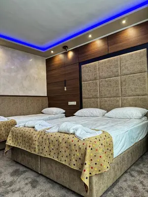 a bedroom with two beds in a room with lights at Hotel Diamant in Dospat