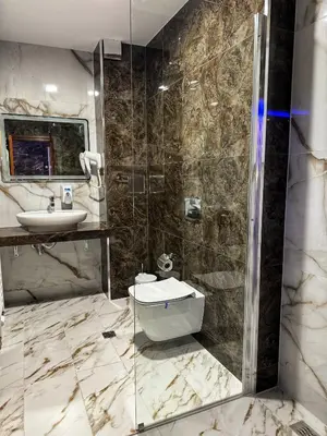 a bathroom with a sink and a shower at Hotel Diamant in Dospat